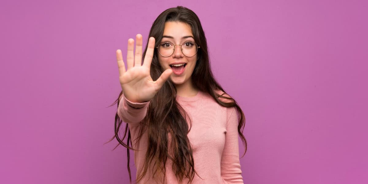 Woman holding up 5