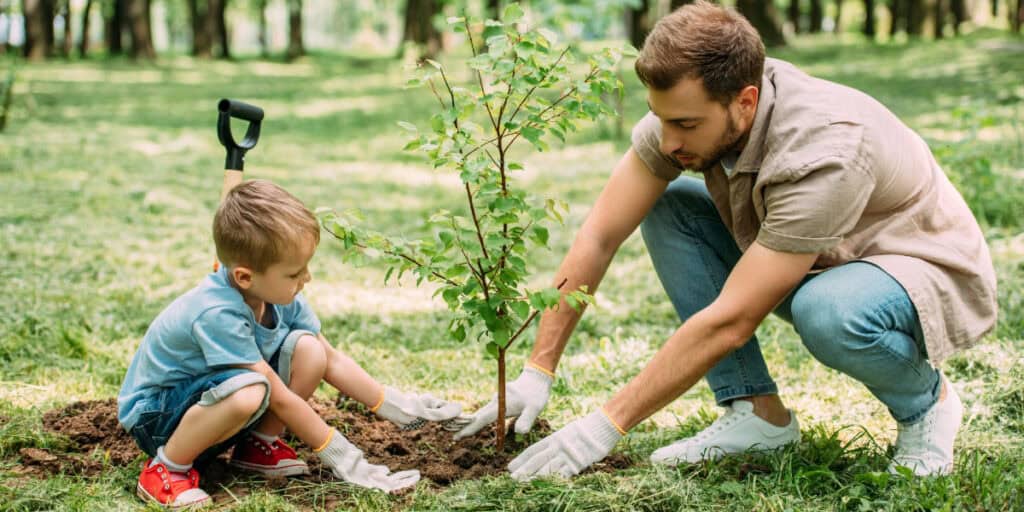 father and son planting a tree