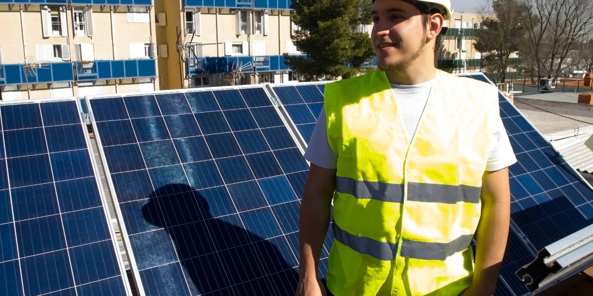 man in front of solar panel