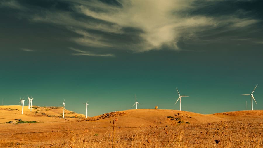 Wind turbines in a grassy landscape emphasizing renewable energy and eco-friendly home solutions.